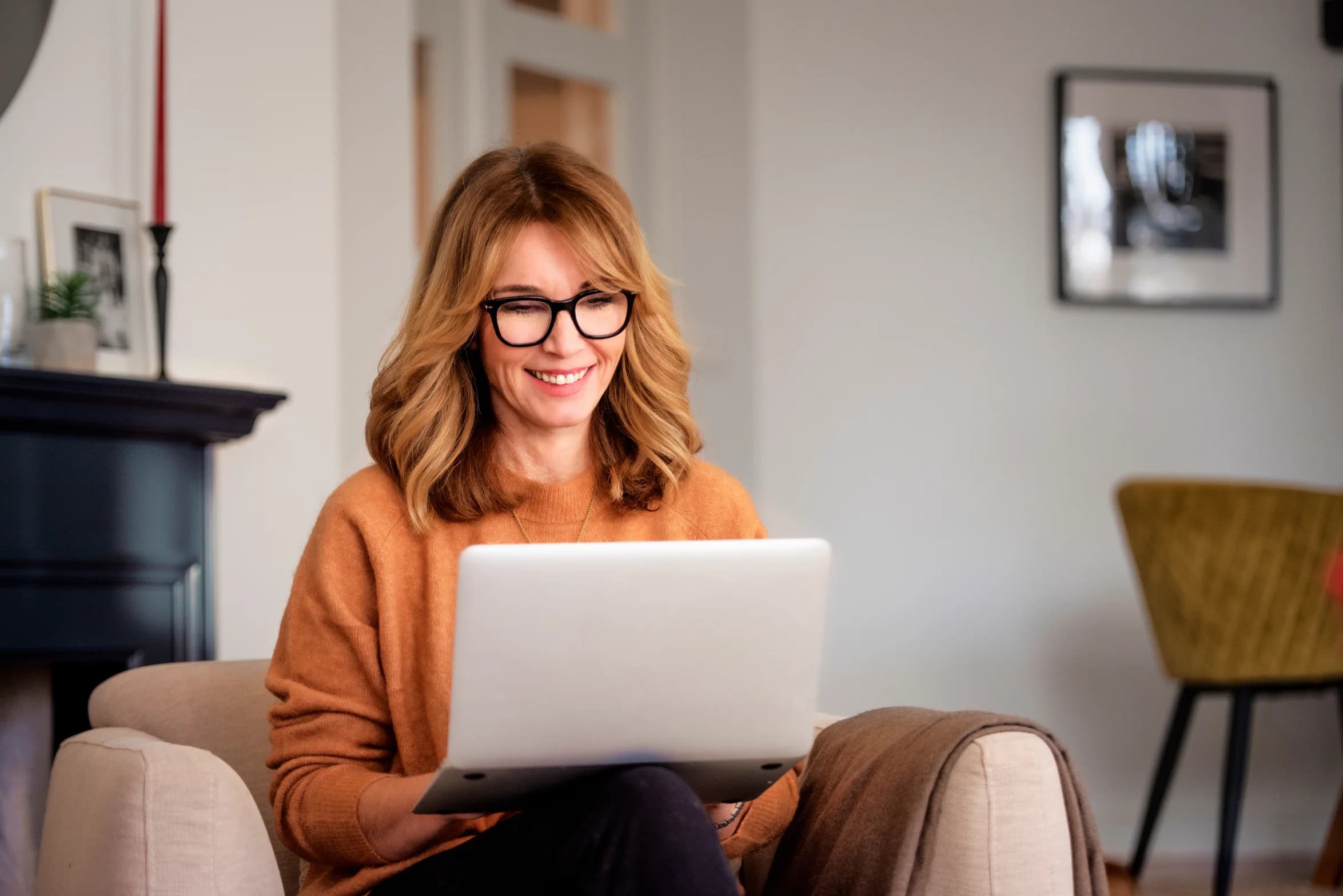Woman sitting at home and using laptop