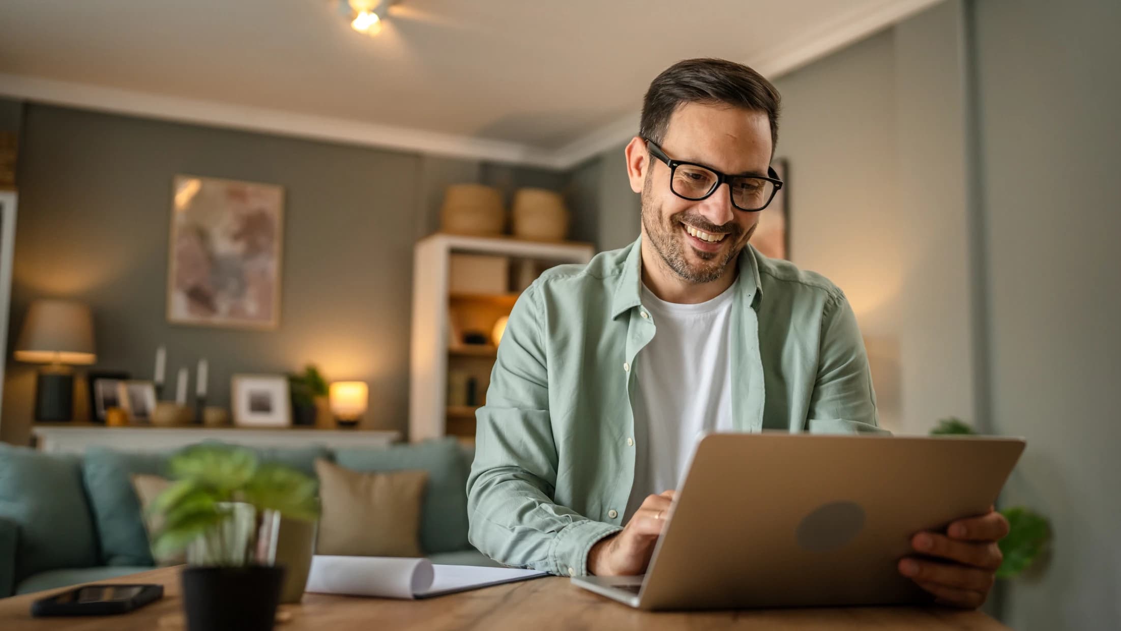 Man happily looking at laptop
