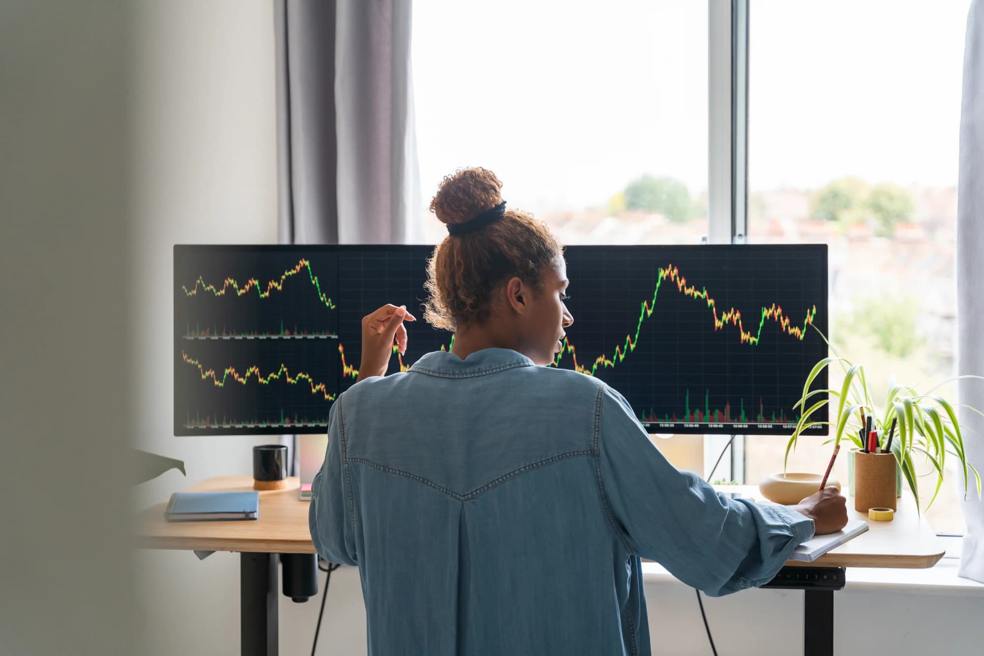 investor-examining-stock-market-charts-and-derivative-instruments-on-laptop-screen